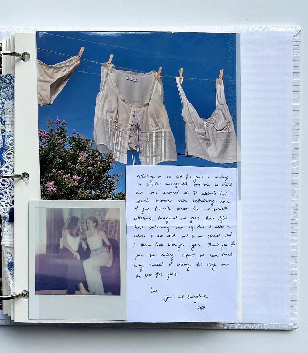 Scrapbook page with clothing on a clothesline, a Polaroid of two women, and a handwritten note