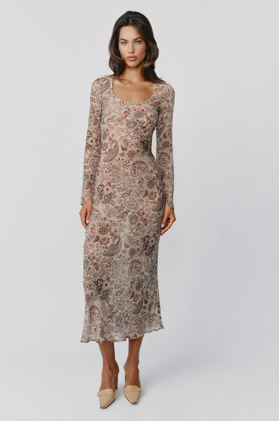 Josephine midi dress in stone paisley print with long sleeves, a scoop neckline, and sheer finish.