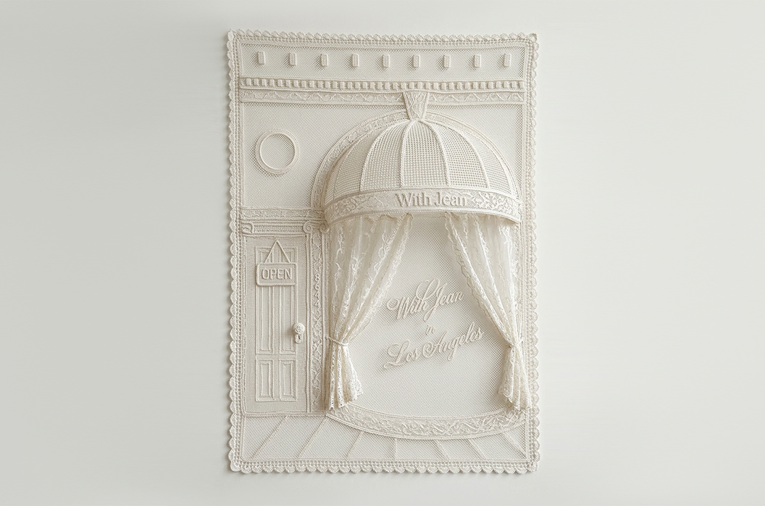 Decorative white wall art with architectural design on a light gray background