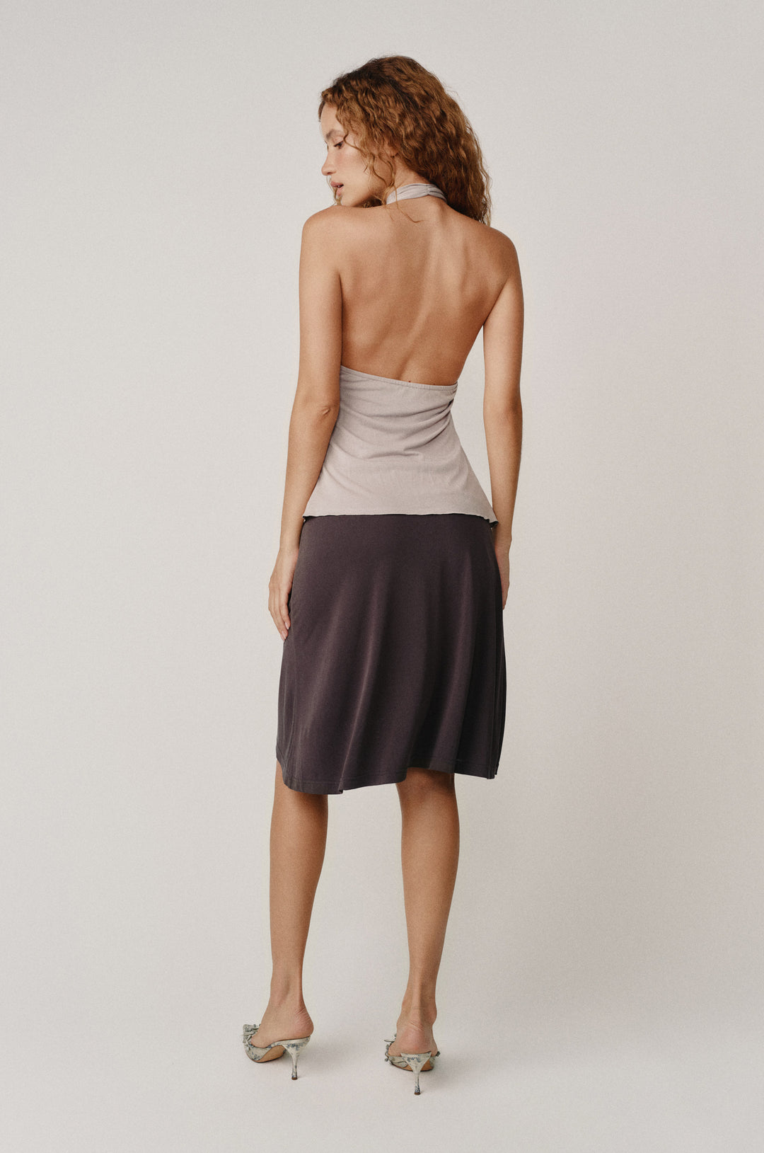 Alix Top in Ash: halter-style, low back, asymmetrical hem, side slit with ruffle.