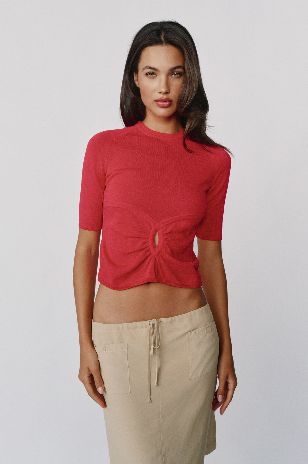 Red knit top with a round neckline, half sleeves, and a gathered front keyhole cut-out detail.