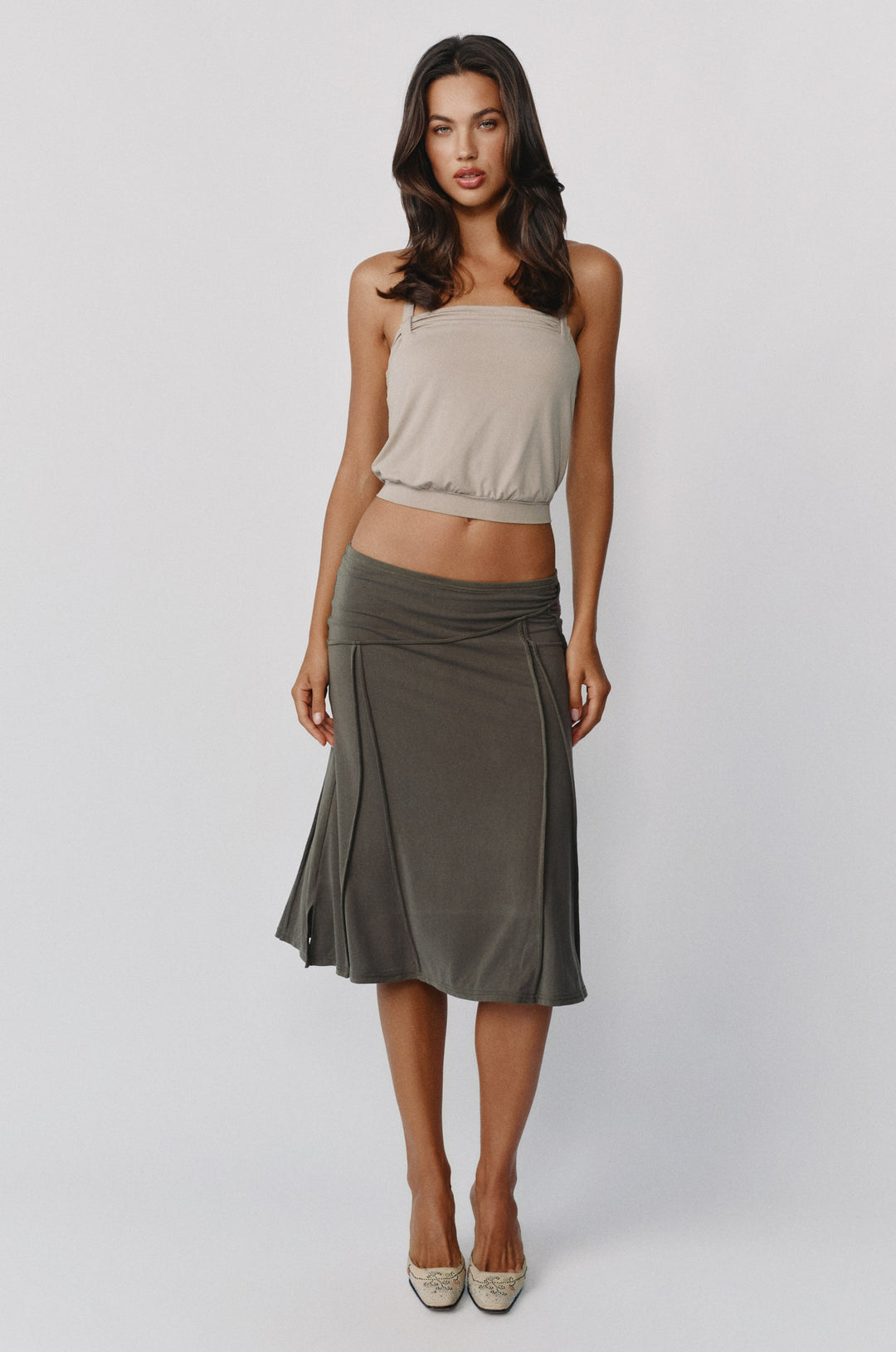 Stone-colored Briar halter top with a ruched band and fitted hem, paired with a dark olive midi skirt.