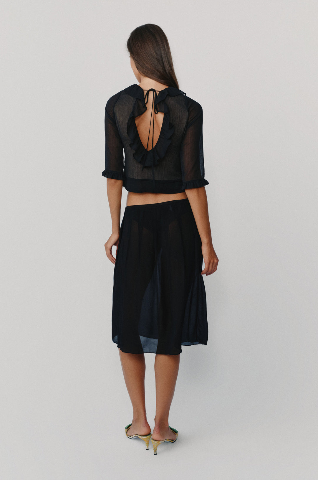 Black low-rise midi skirt with a soft pleated silhouette and picot-edge elasticated waistband.