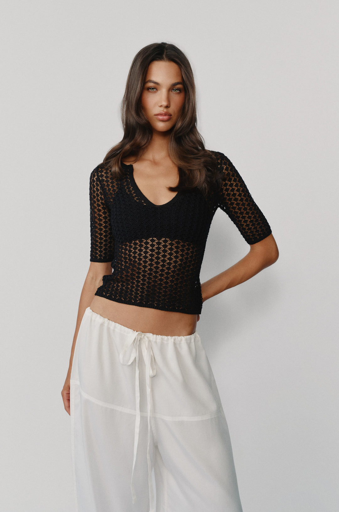 Black knitted Delilah top with half sleeves, a notched scoop neckline, and contrast rib detailing.
