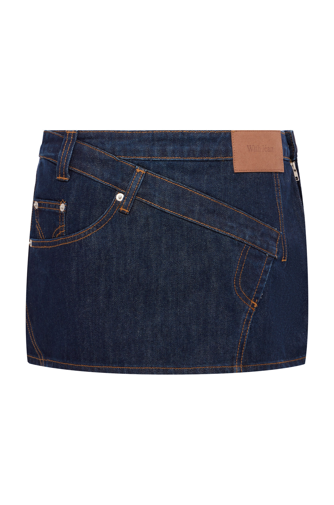 Indigo blue denim mini skirt with low-rise fit, asymmetric paneling, contrast stitching, and a tan leather back patch.