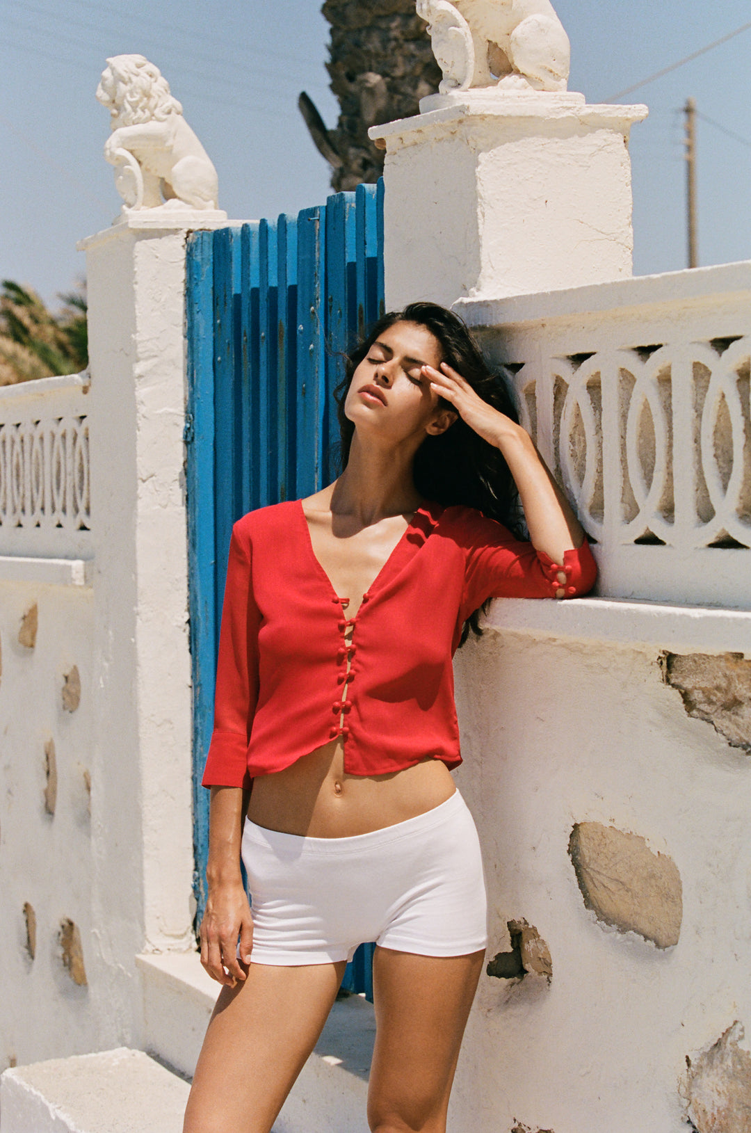 Red V-neck Elsie blouse with loop button-front closure and 3/4 length sleeves with split cuffs.