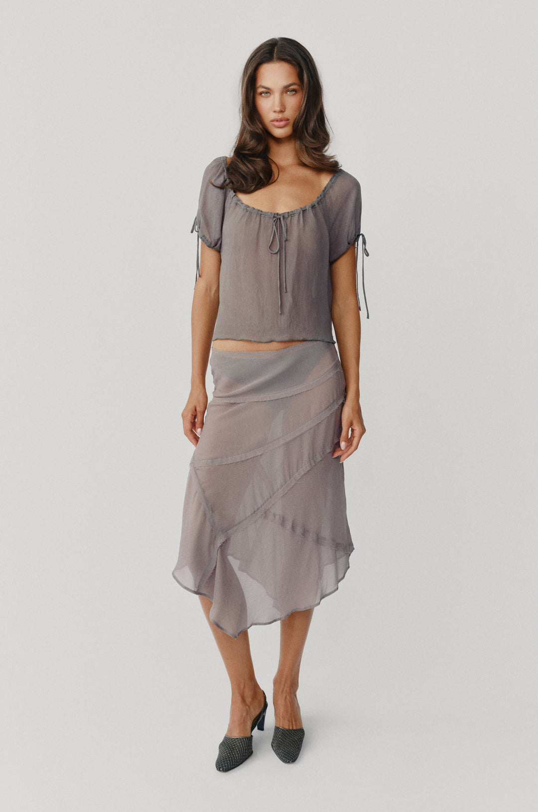 Dusty slate sheer low-rise Gia skirt with frayed-edge panel detailing and an asymmetrical hem.