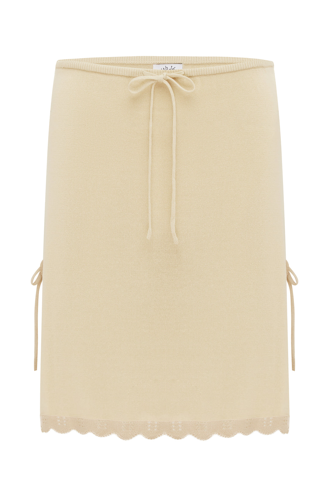 Beige low-rise knit Isla skirt with drawstring waist, side tie-up slits, and a scalloped contrast trim hem.