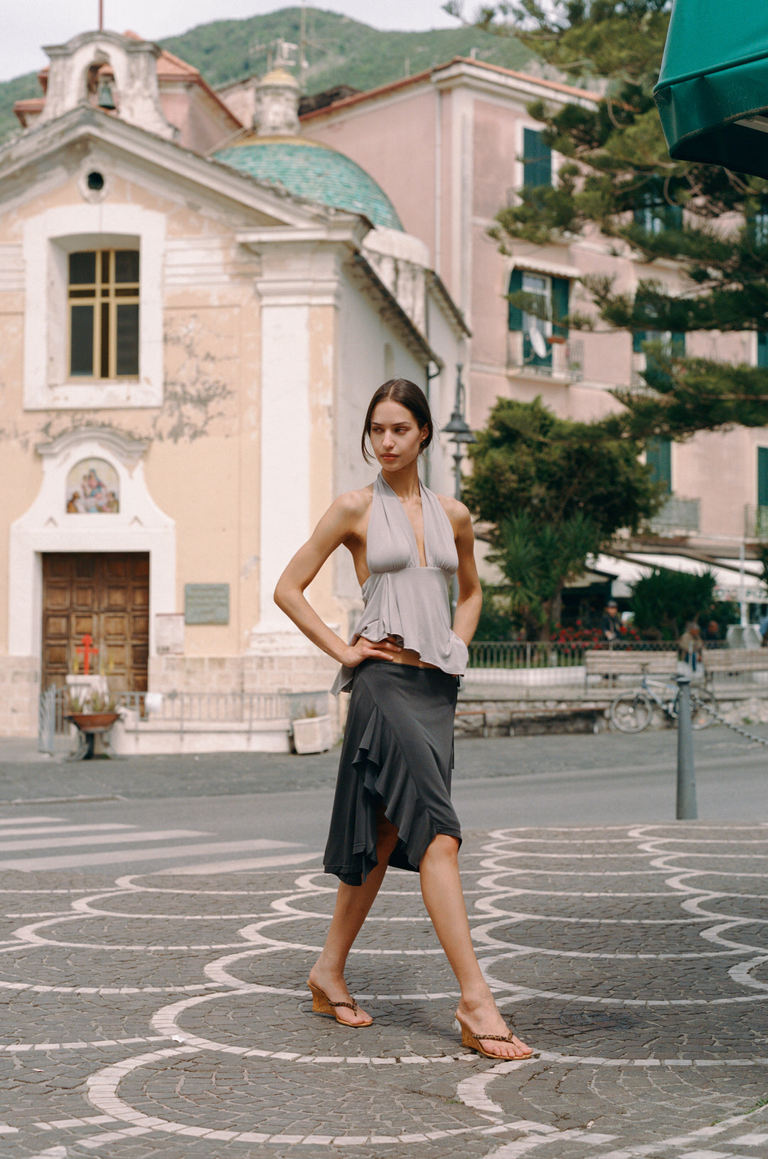 Jolene Skirt in charcoal, a low-rise midi with adjustable tie waist and ruffled side slit, worn by a model.