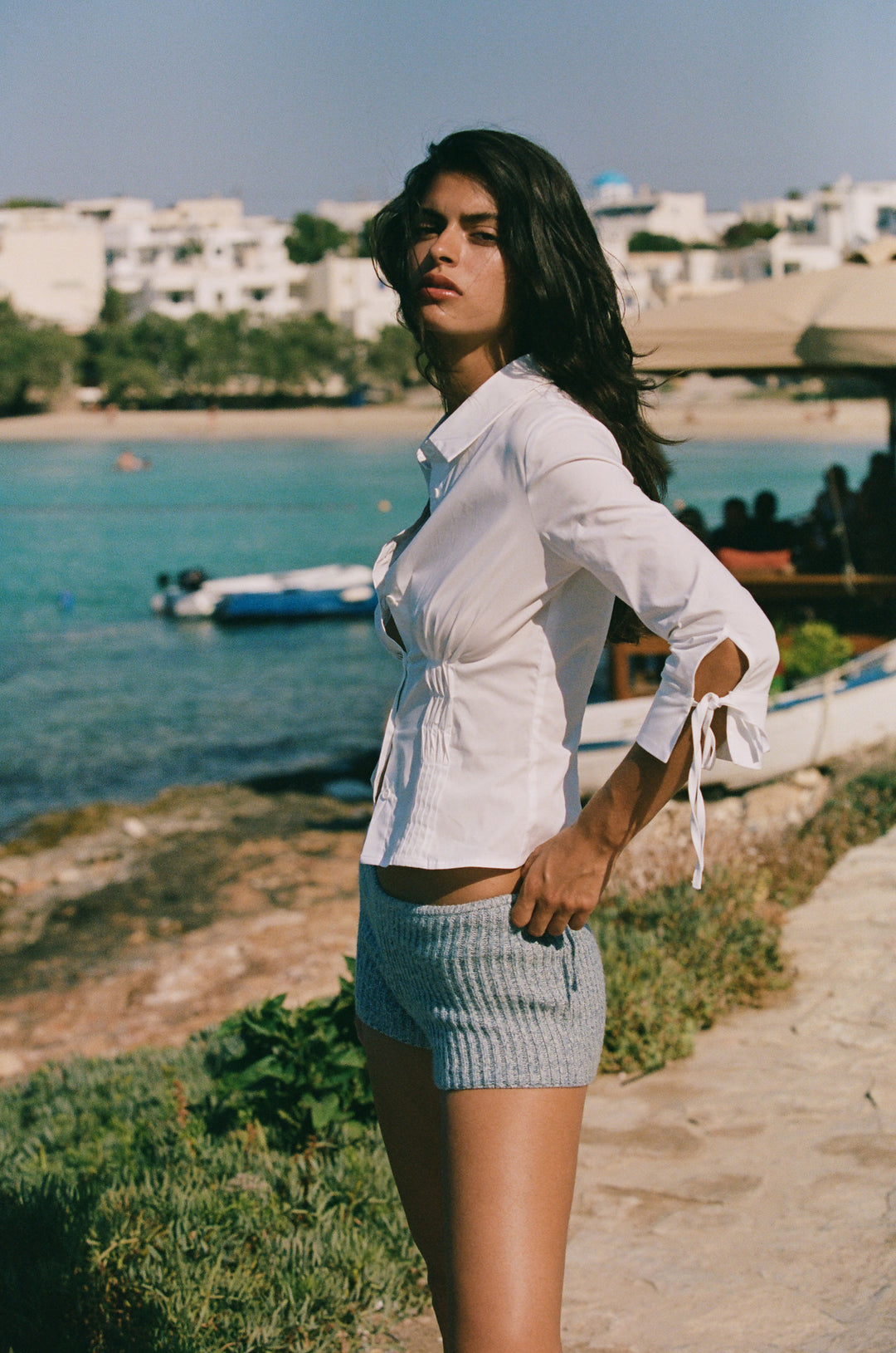 Fitted white button-down Lauren top with pintuck waist and 3/4 sleeves featuring split cuffs and self-tie closures.