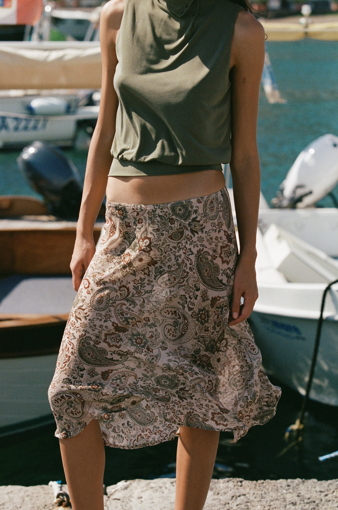 Olea skirt in stone paisley print featuring a sheer, lightweight fabric worn low on the hips with a midi-length silhouette.