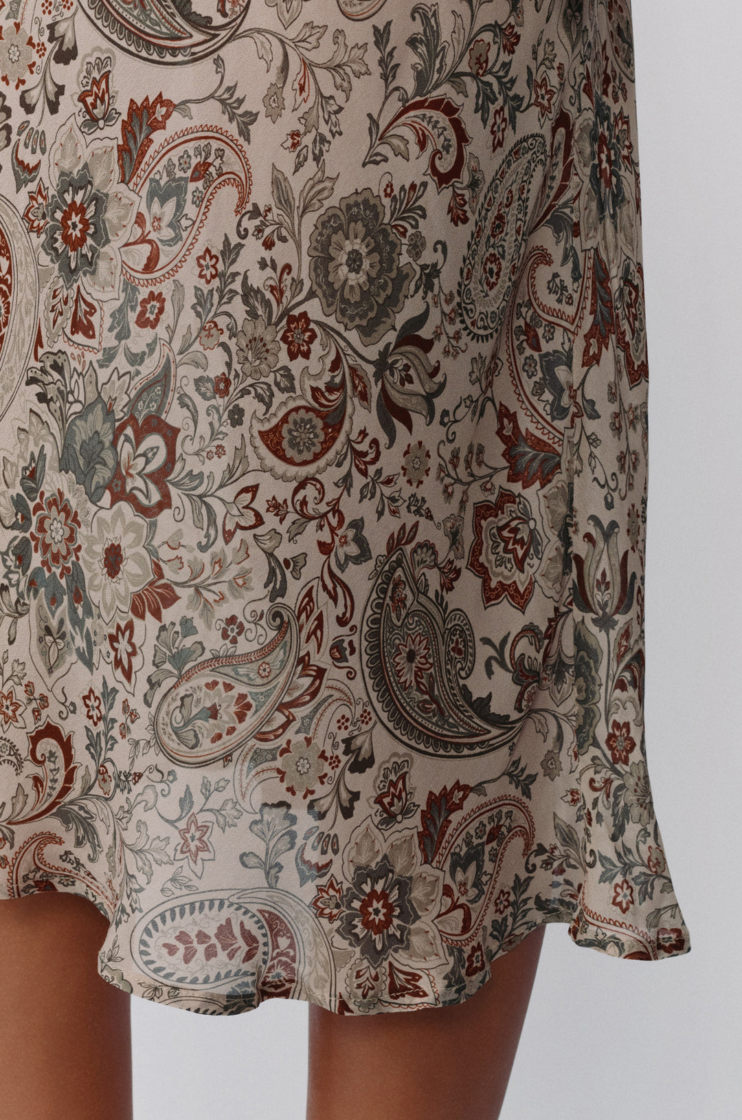 Olea skirt in stone paisley print featuring a sheer, lightweight fabric with intricate floral and teardrop patterns.