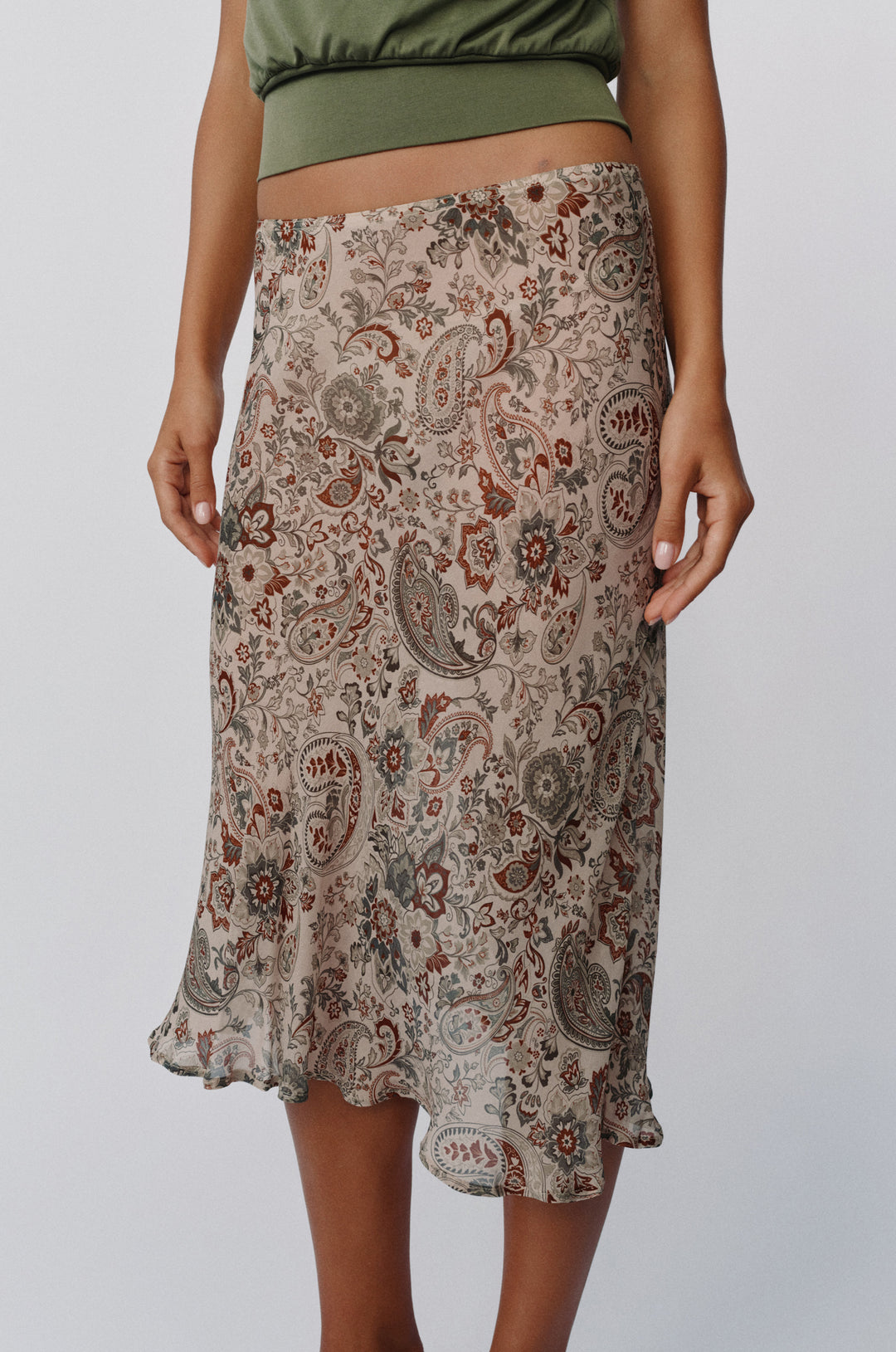 Olea midi skirt in stone paisley print with a sheer finish, styled to sit low on the hips.