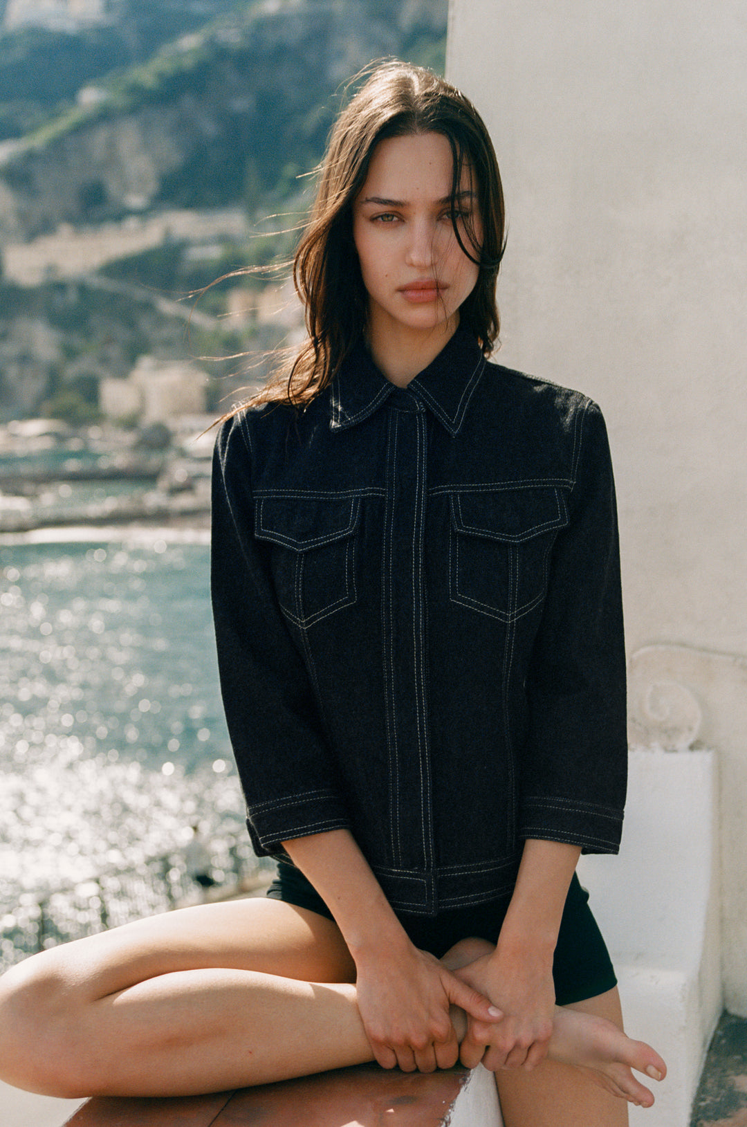 Olivia Indigo denim jacket with 3/4 sleeves, front buttons, flap pockets, and contrast stitching.