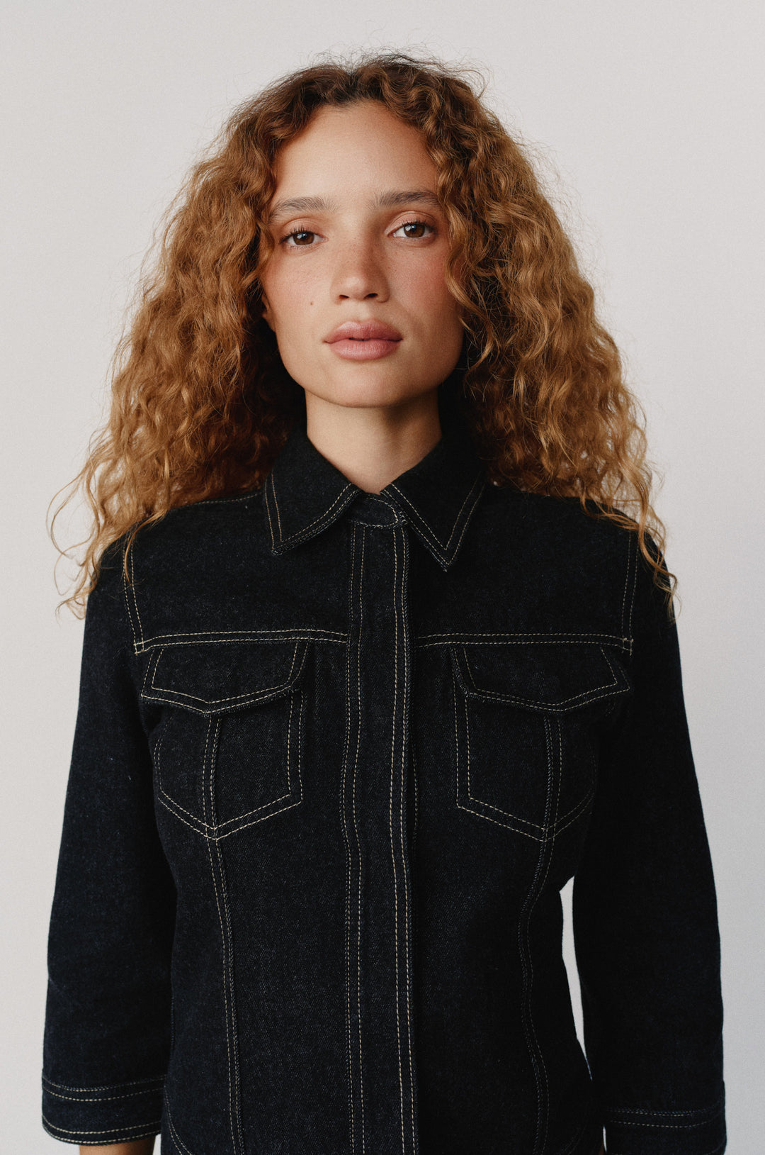 Olivia Jacket in indigo denim with contrast stitching, collared neckline, and front flap pockets.