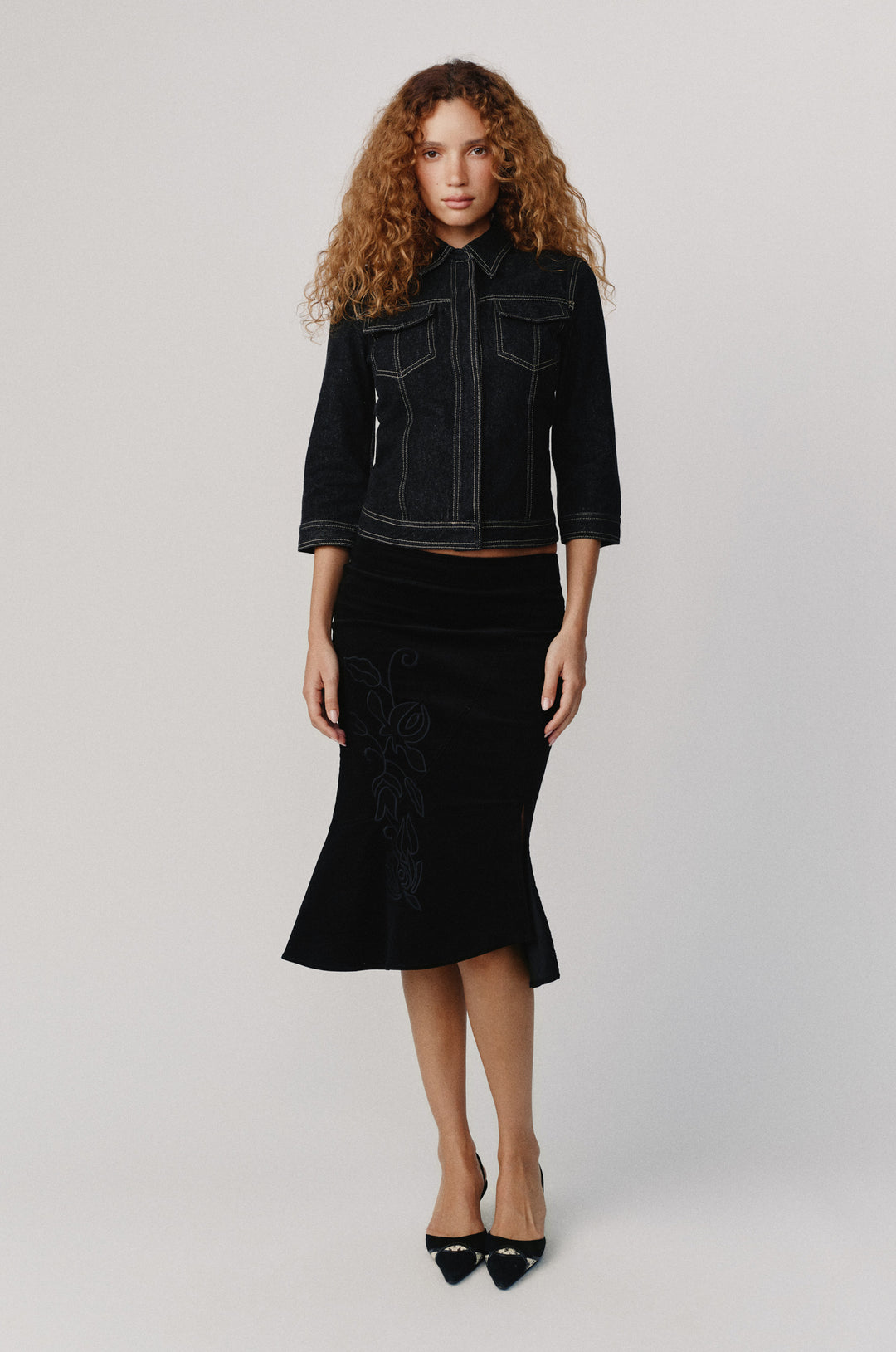 Olivia Jacket in indigo denim with 3/4 sleeves, front buttons, flap pockets, and contrast stitching.