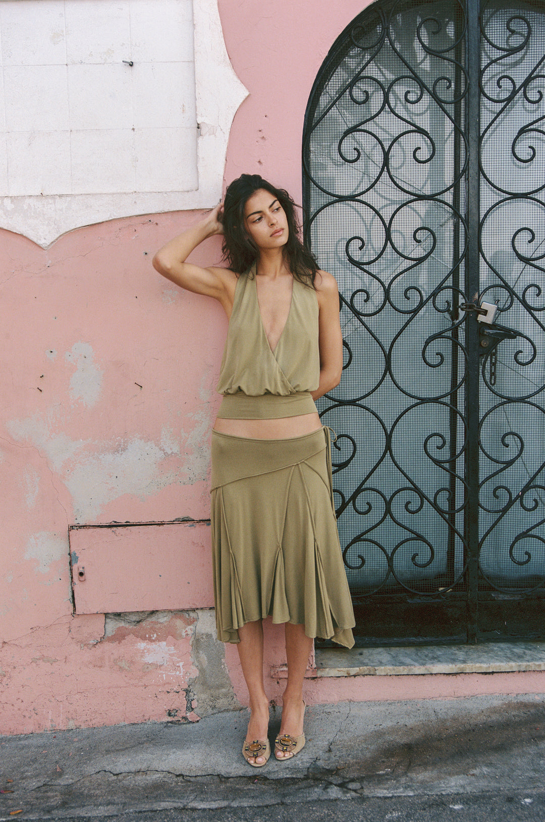 Olive Sharni midi skirt with adjustable tie waistband, worn low on hips.