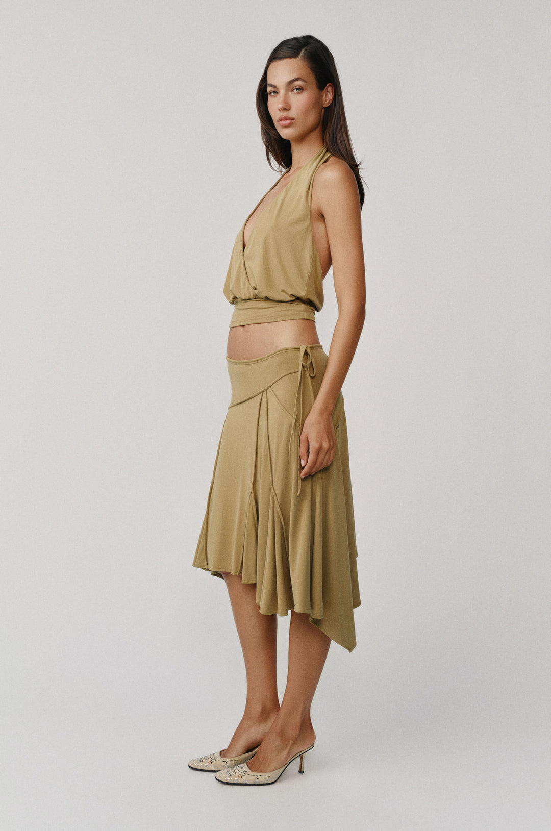 Olive Sharni Top: halter-style, V-neck wrap top with fitted hem, paired with a matching skirt.