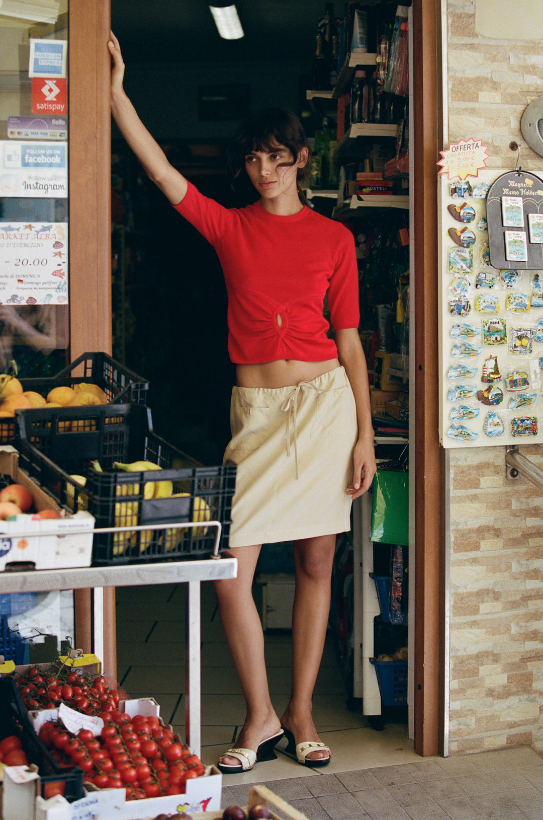 Beige low-rise Thea skirt featuring an adjustable drawstring waist and front patch pockets with button detailing.