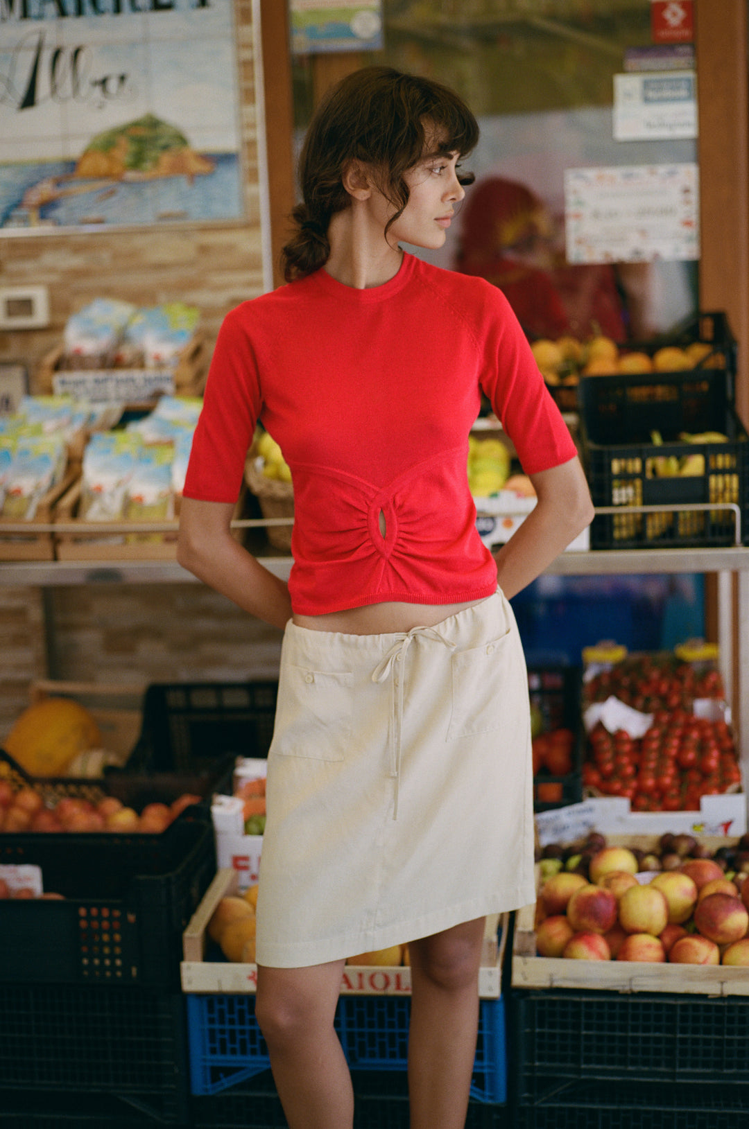 Beige low-rise Thea skirt with an adjustable drawstring waist, front patch pockets, and button detailing.