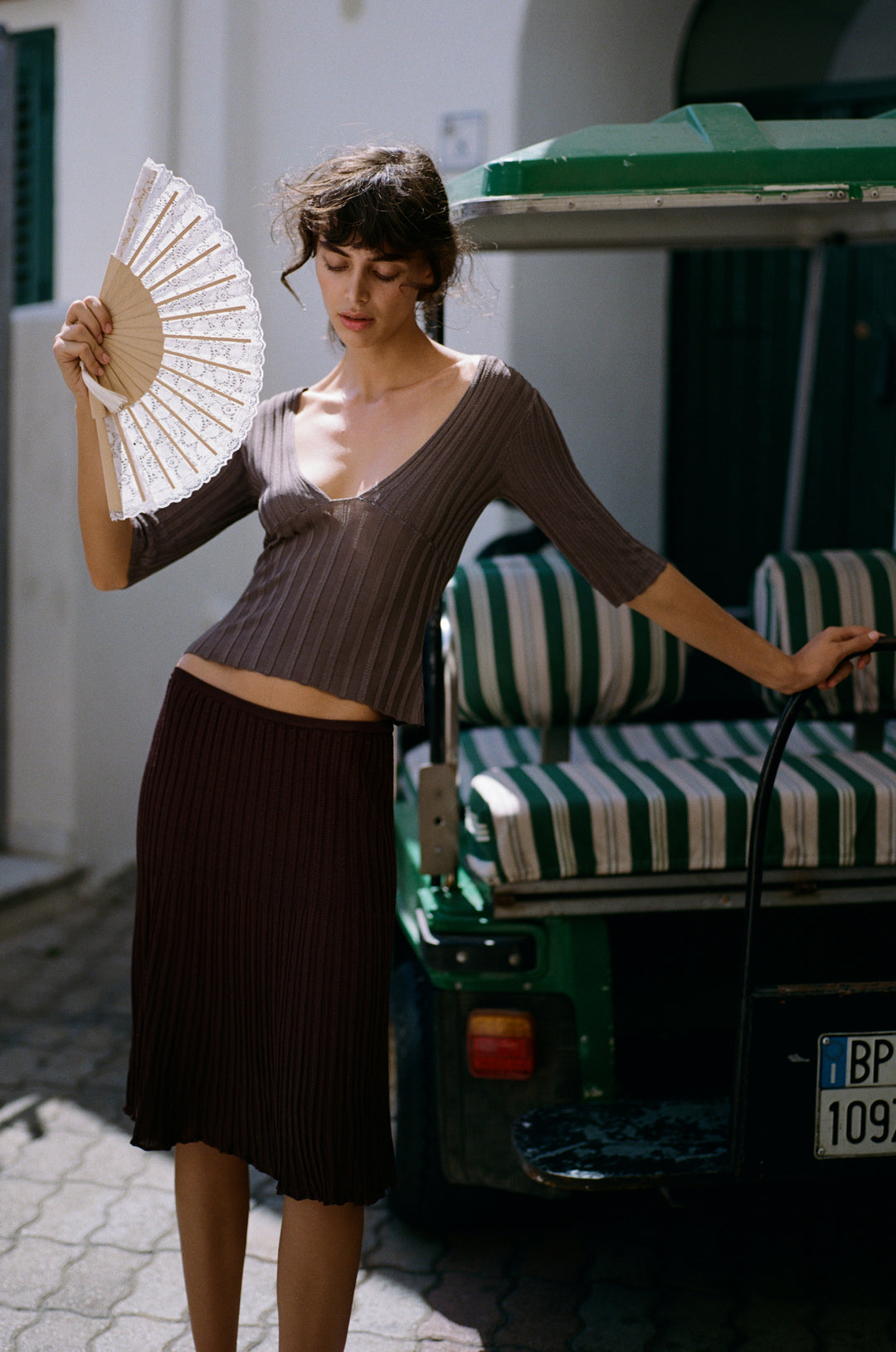 Chocolate brown ribbed-knit midi skirt with an elasticated waistband worn with a matching ribbed top.