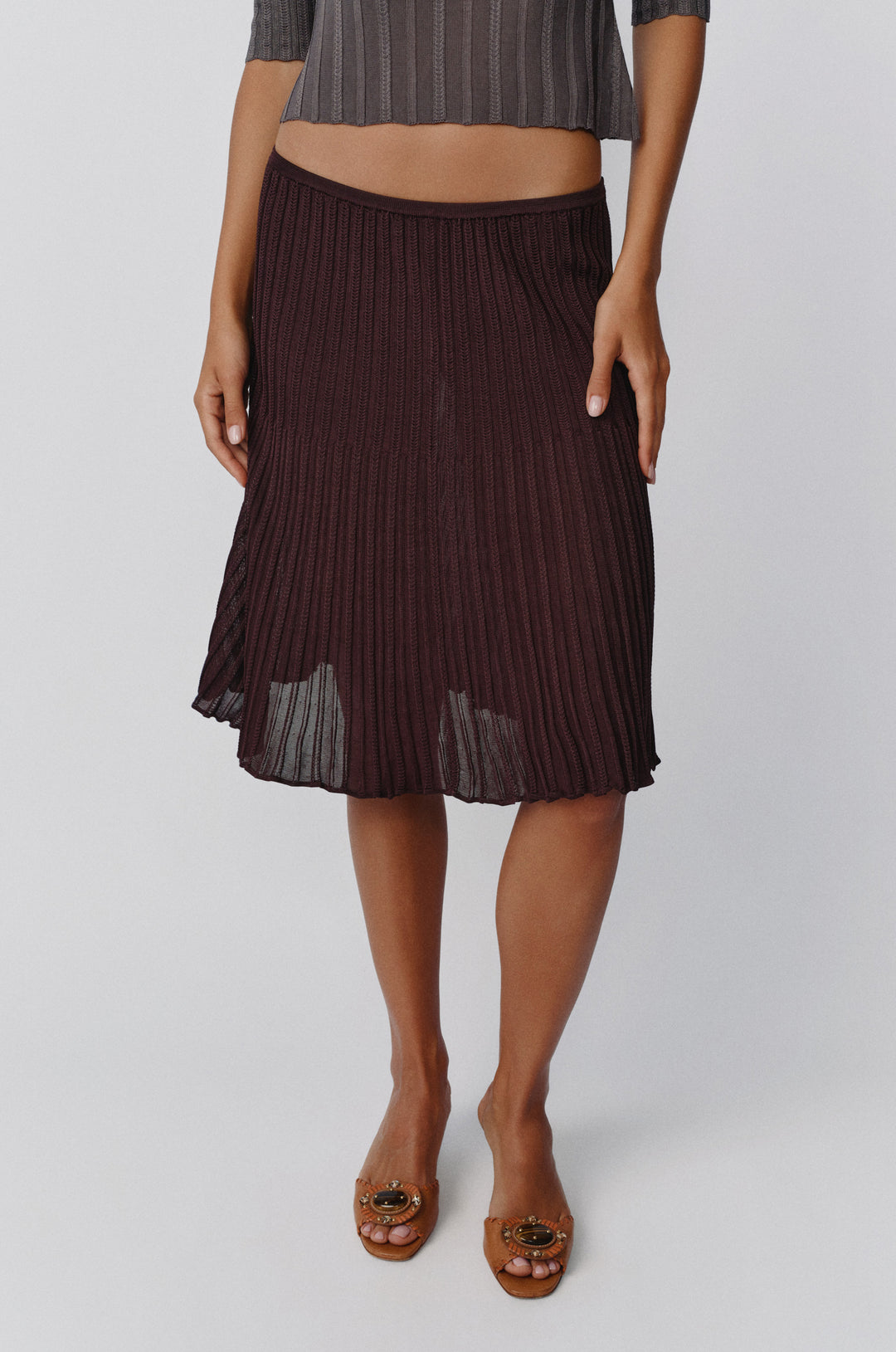 Chocolate brown ribbed-knit midi skirt with an elasticated waistband and contrasting vertical rib detailing.