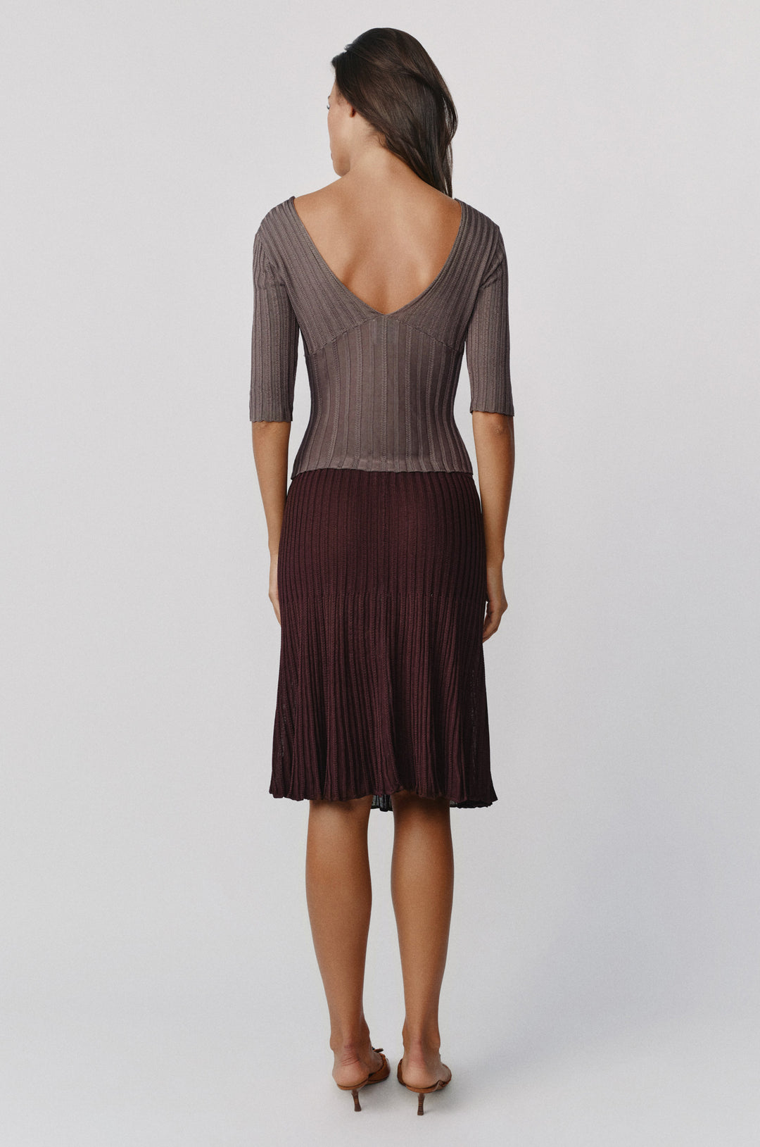 Chocolate brown ribbed-knit midi skirt with an elasticated waistband and contrasting vertical rib detailing.