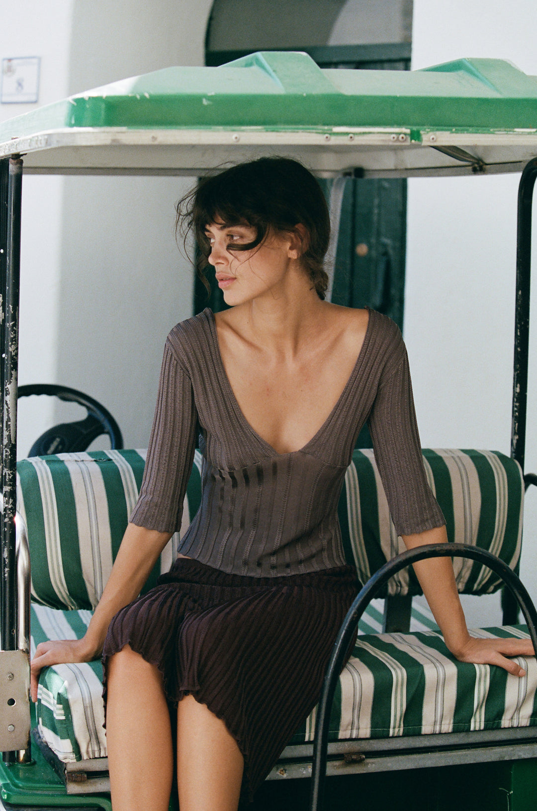 Smoke grey ribbed-knit V-neck top with half sleeves and contrasting rib detailing worn by a woman.